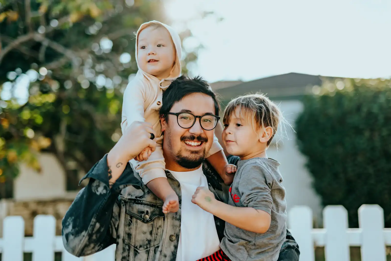 Father carrying his daughter outside their home