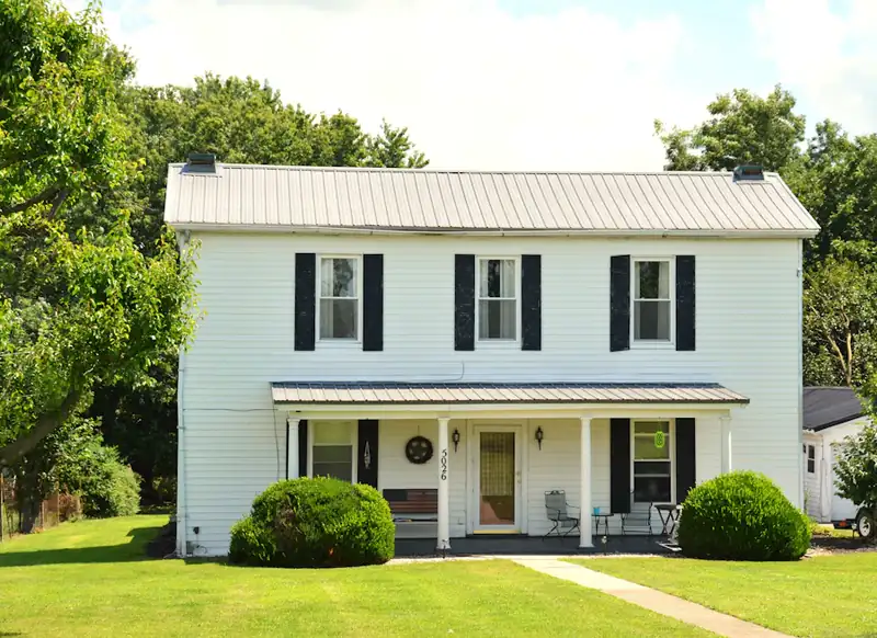 Two-story white house with black shutters