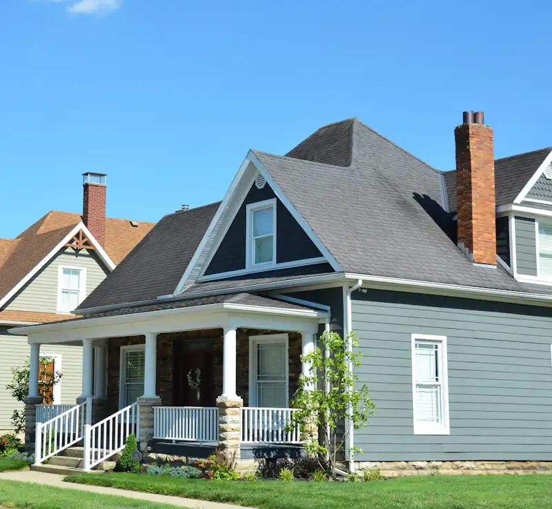 Blue house with white porch and red chimney