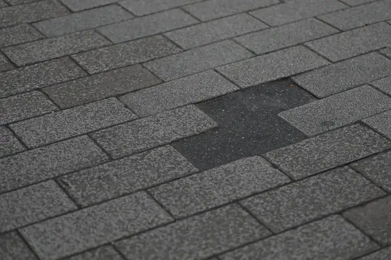 Shingle roof with missing shingles after a storm